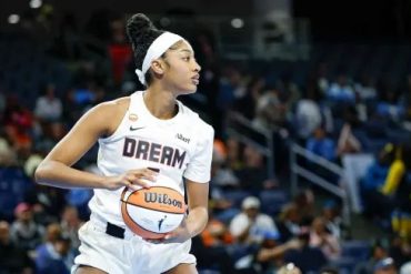Angel Reese holding a basketball during an Atlanta Dream game in 2026