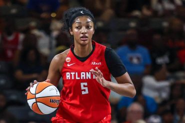 Angel Reese handles the ball in her red Atlanta Dream jersey during a 2026 playoff game
