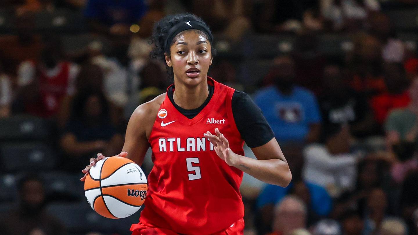 Angel Reese handles the ball in her red Atlanta Dream jersey during a 2026 playoff game