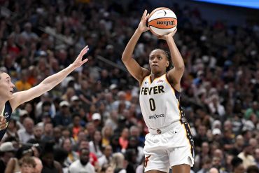 Indiana Fever guard Kelsey Mitchell (No. 0) shooting over a defender during a game