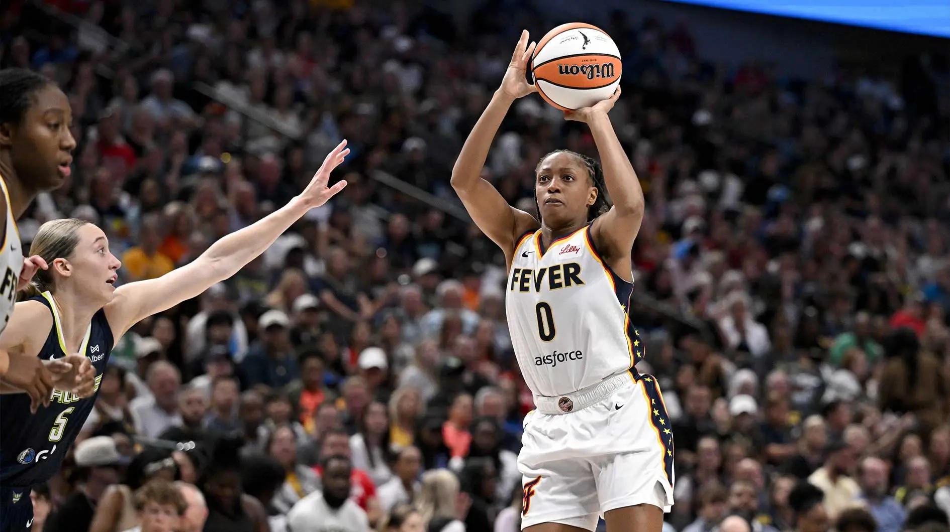 Indiana Fever guard Kelsey Mitchell (No. 0) shooting over a defender during a game