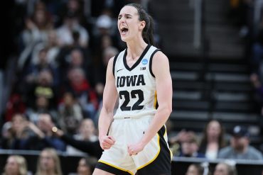 Caitlin Clark celebrates in her Iowa Hawkeyes jersey; she returned to Iowa City as ESPN's College GameDay guest picker on October 3