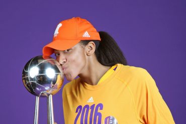 A WNBA player kisses the championship trophy — the prize on the line in the 2026 WNBA Finals