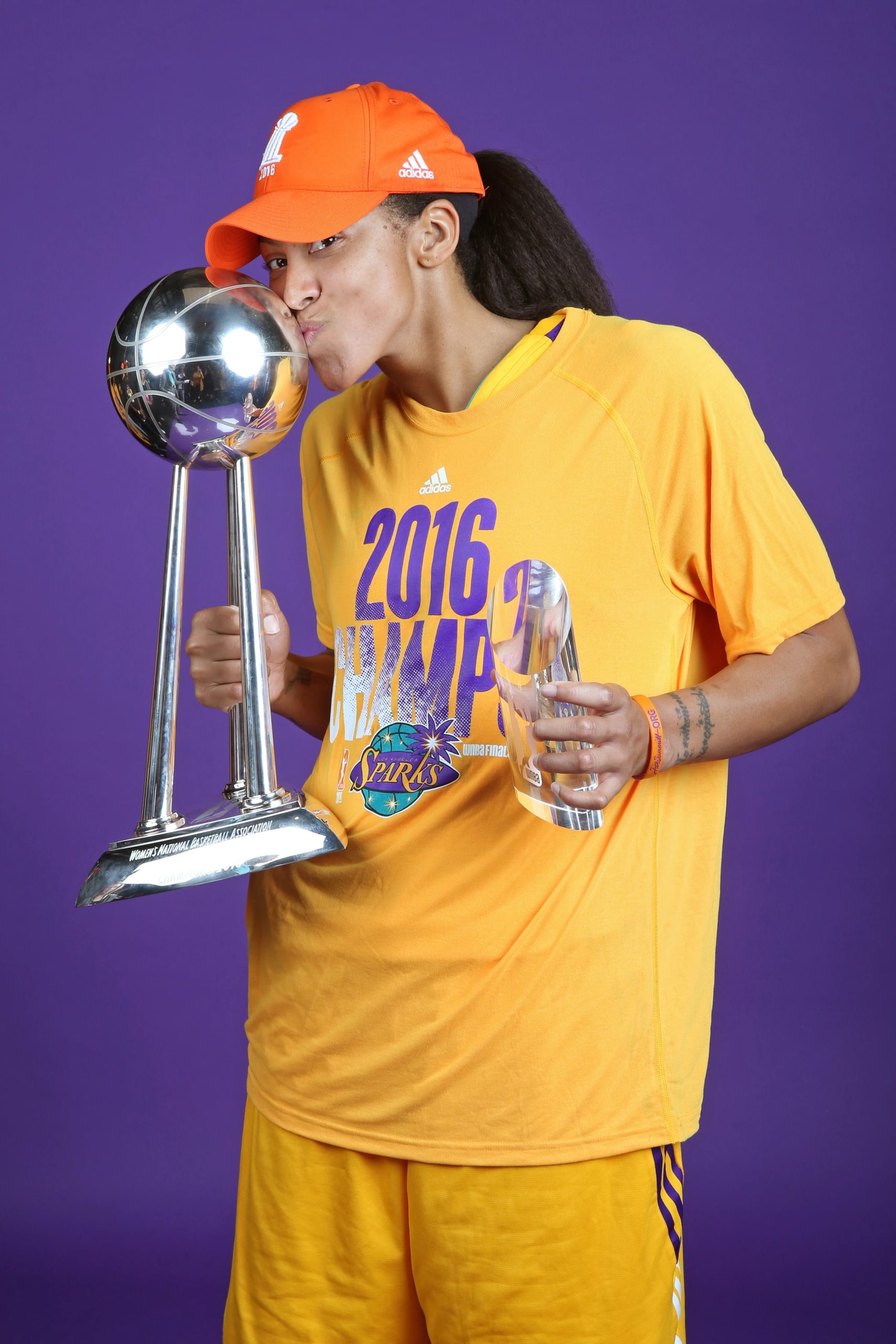 A WNBA player kisses the championship trophy — the prize on the line in the 2026 WNBA Finals